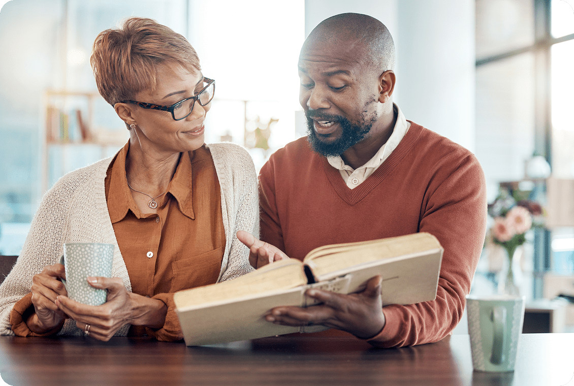 Two colleagues discussing work with a tablet and documents.